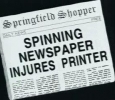 SPINNING NEWSPAPER INJURES PRINTER (Springfield Shopper)