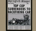 TOP COP SURRENDERS TO BACKFIRING CAR (Springfield Shopper)